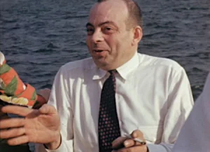 Autor do livro, Anoine S.E, homem calvo, branco, cabelo raspado, cara um pouco arredondada, ele usa camisa social e gravata, está com uma cara alegre como se estivesse contando algo. 